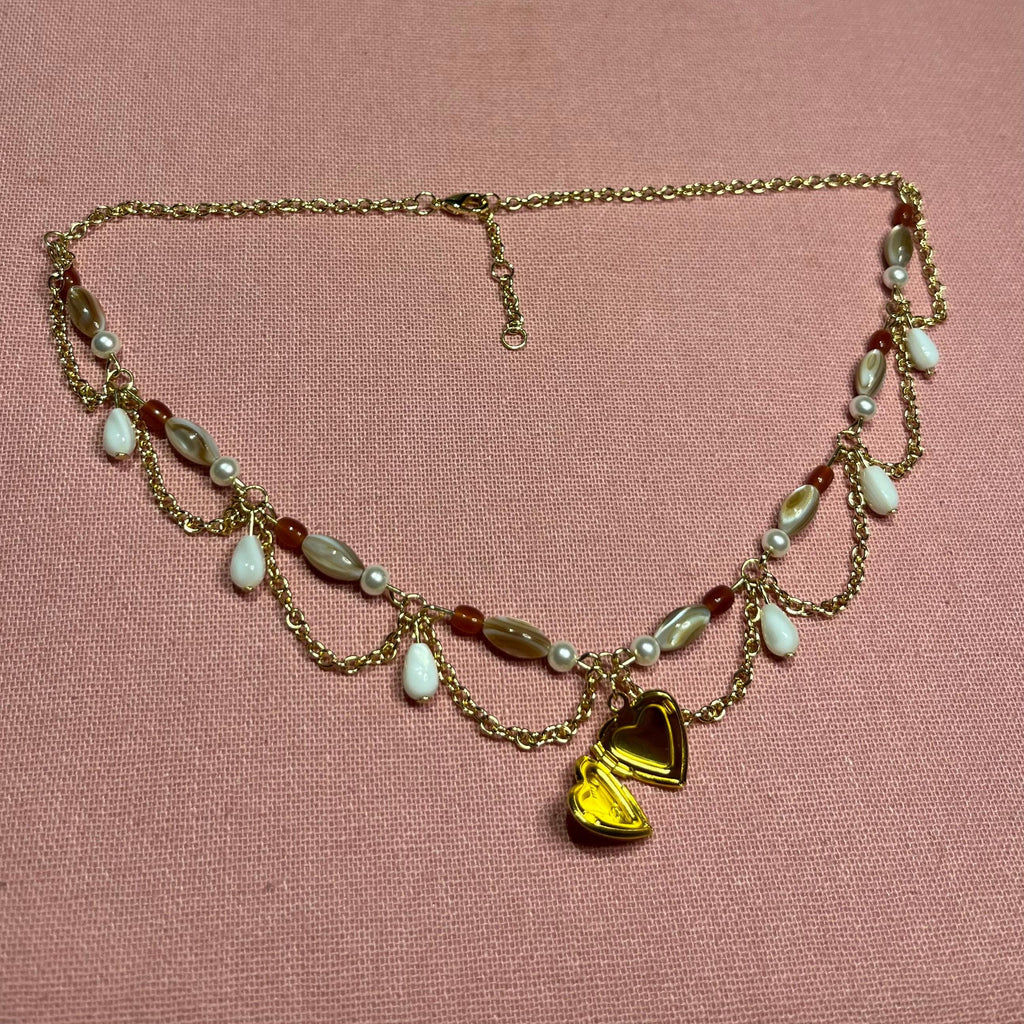 Darling Dynasty: Gold Heart Locket Necklace with Gold Chain and White/Amber Beading